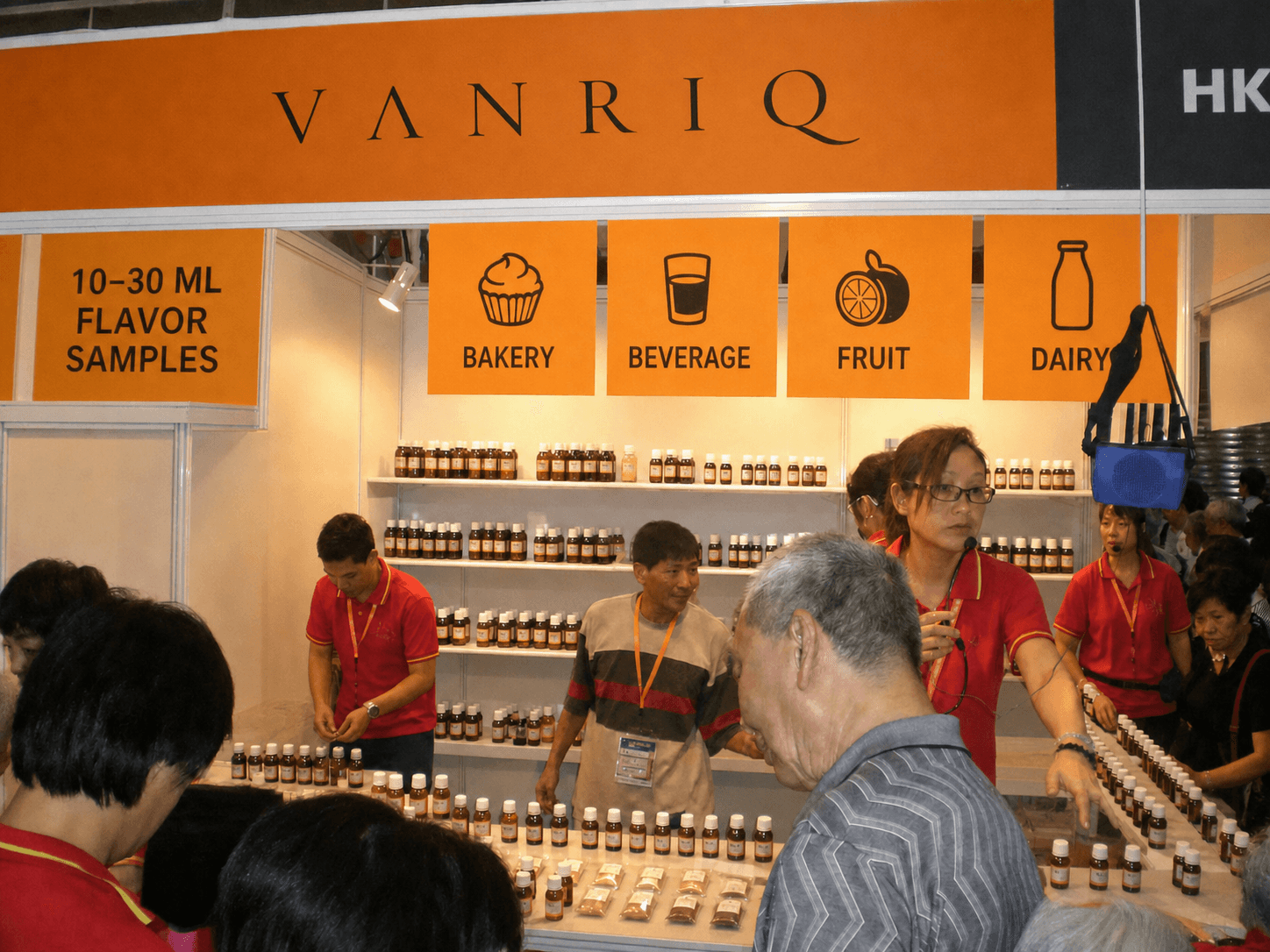 Visitors evaluating food flavor samples at the Vanriq exhibition counter