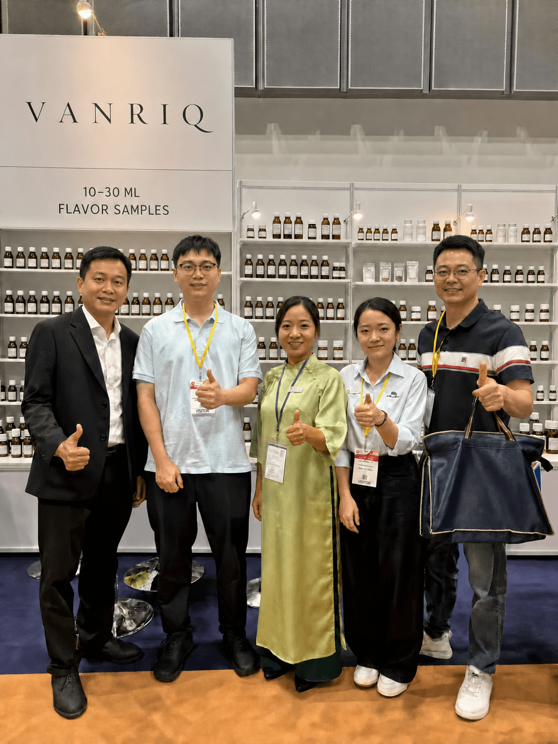 Vanriq team and visitors in front of the exhibition sample display