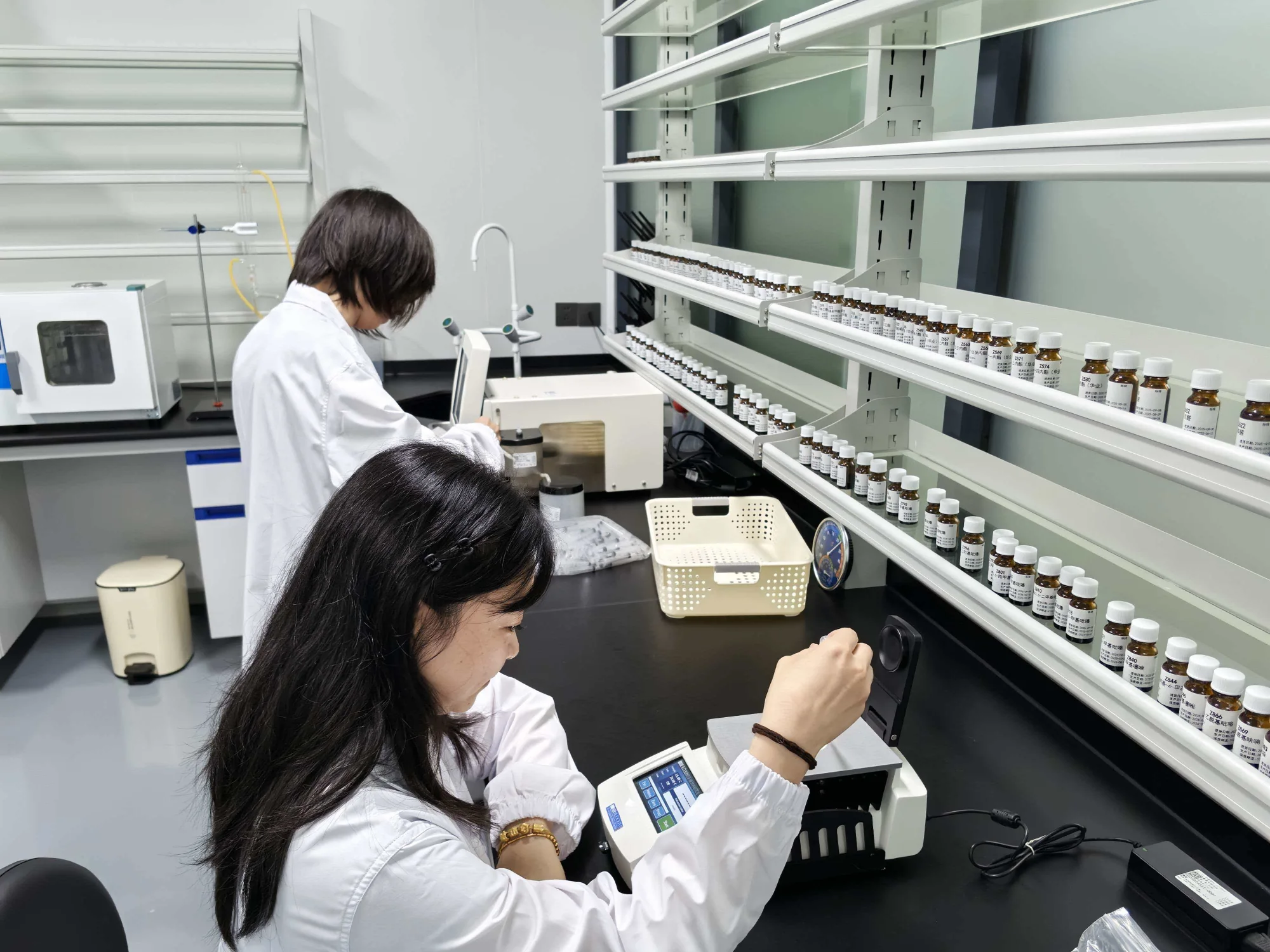 Flavor analyst testing a sample beside the laboratory reference library